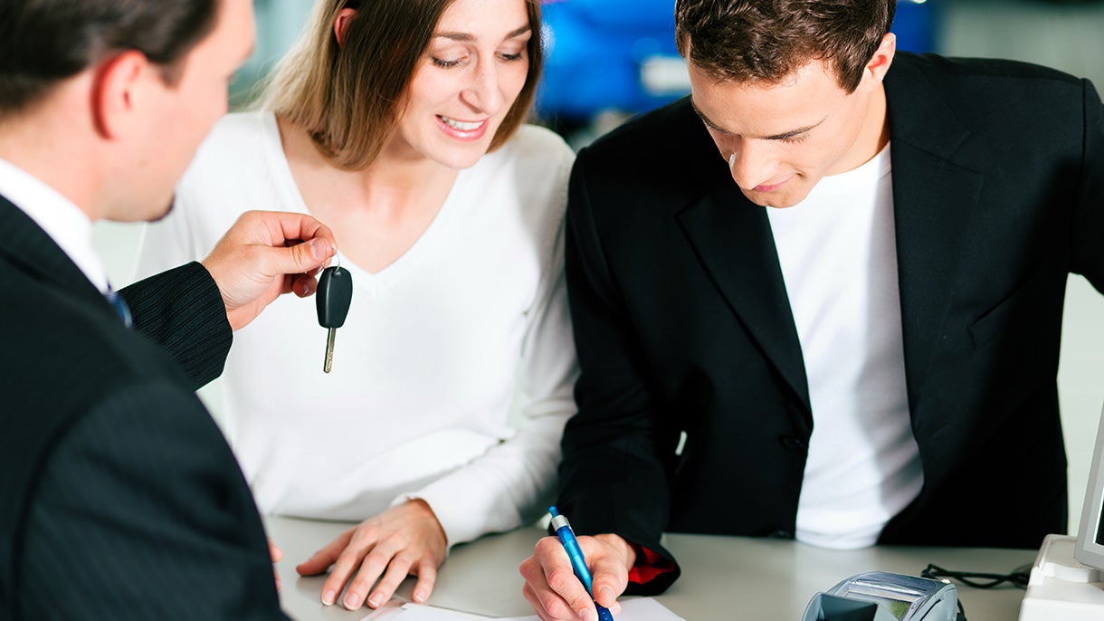 couple getting car keys from salesman Alexander Cadillac in Oxnard CA